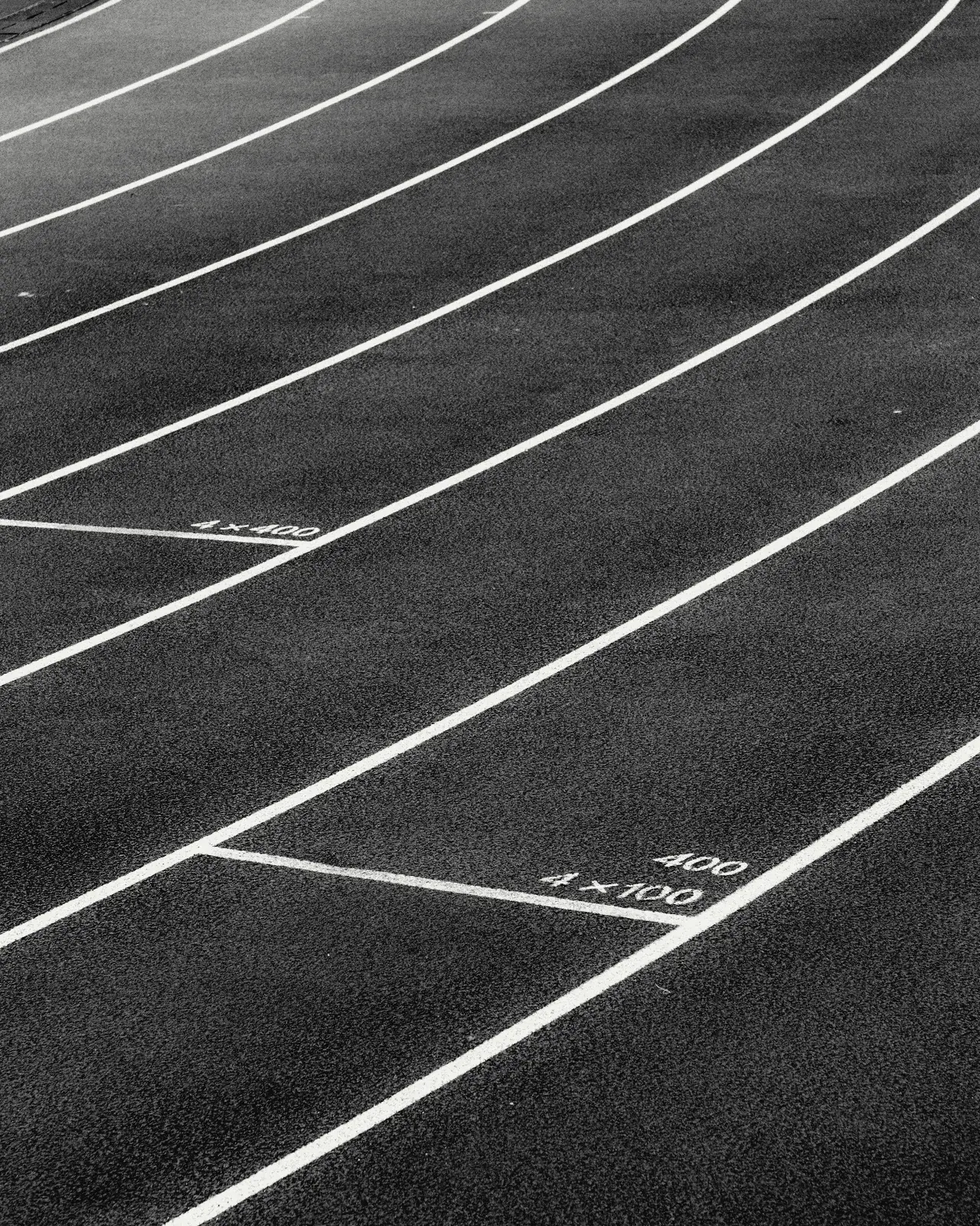 Curving track lanes with painted distance markings.